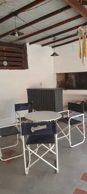 a ping pong table and two chairs in a room at MabiSil in Mina Clavero