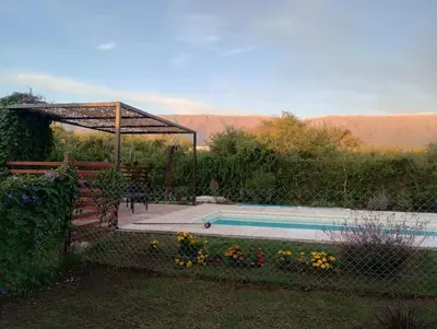 a swimming pool in a yard with a fence at Arawi Cabaña in Merlo