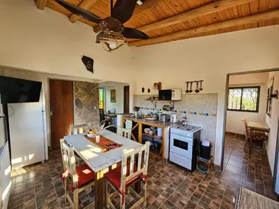 a kitchen with a table and a stove top oven at Arawi Cabaña in Merlo