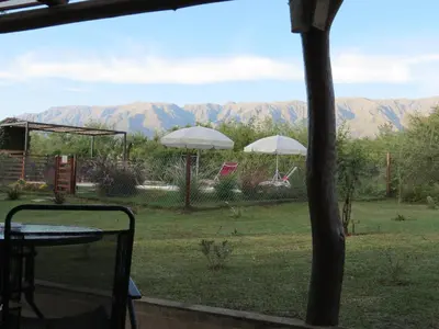 a view of a patio with mountains in the background at Arawi Cabaña in Merlo