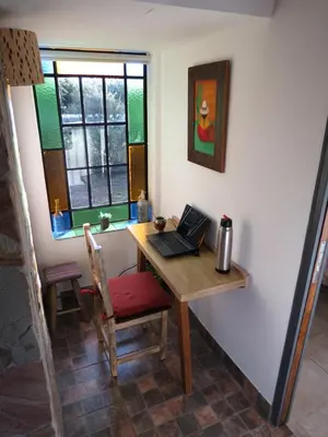 a room with a desk with a laptop on it at Arawi Cabaña in Merlo