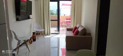 a living room with a couch and chairs and a patio at Marta Demarchi in Villa Carlos Paz