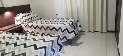 a room with two beds with black and white patterns at Marta Demarchi in Villa Carlos Paz