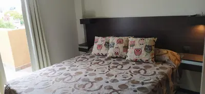 a bed with two pillows and a headboard and a window at Marta Demarchi in Villa Carlos Paz