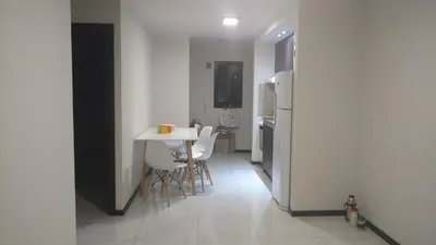 a kitchen with a table and chairs and a refrigerator at Marta Demarchi in Villa Carlos Paz