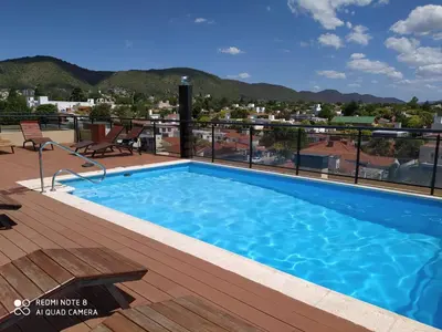 a swimming pool on the roof of a building at Marta Demarchi in Villa Carlos Paz