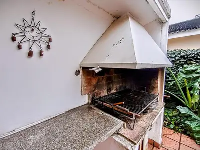 an outdoor oven with a sun sign on a wall at Alquilo Dpto en Villa Carlos Paz in Villa Carlos Paz