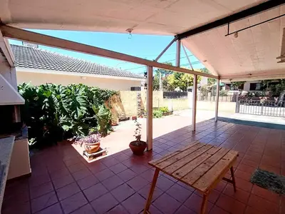 a patio with a wooden table on a patio at Alquilo Dpto en Villa Carlos Paz in Villa Carlos Paz