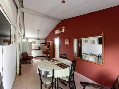a kitchen and dining room with a table and chairs at Alquilo Dpto en Villa Carlos Paz in Villa Carlos Paz