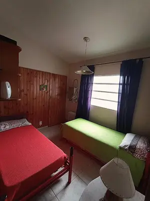 a bedroom with two beds and a window at Alquilo Dpto en Villa Carlos Paz in Villa Carlos Paz