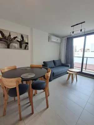 a living room with a table and chairs and a couch at Av Velez Sarsfield 700 B Nueva Cordoba in Cordoba
