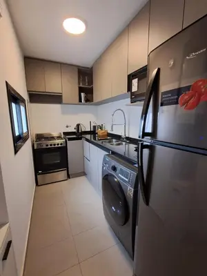 a kitchen with a washer and dryer in it at Av Velez Sarsfield 700 B Nueva Cordoba in Cordoba