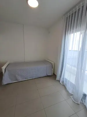 a bedroom with a bed and a large window at Av Velez Sarsfield 700 B Nueva Cordoba in Cordoba