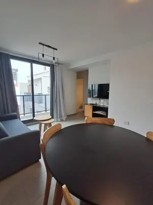 a living room with a table and a couch at Av Velez Sarsfield 700 B Nueva Cordoba in Cordoba