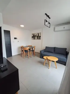 a living room with a blue couch and a table at Av Velez Sarsfield 700 B Nueva Cordoba in Cordoba