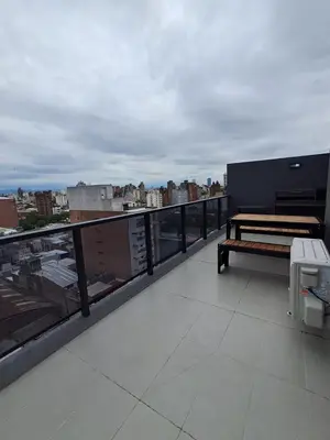 a balcony with a bench and a view of a city at Av Velez Sarsfield 700 B Nueva Cordoba in Cordoba