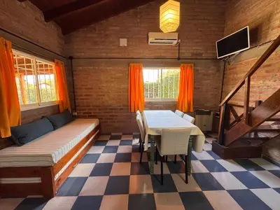 a room with a bed and a table in a room at Casa Terra in Mina Clavero