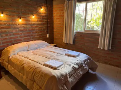 a bedroom with a large bed with towels on it at Casa Terra in Mina Clavero