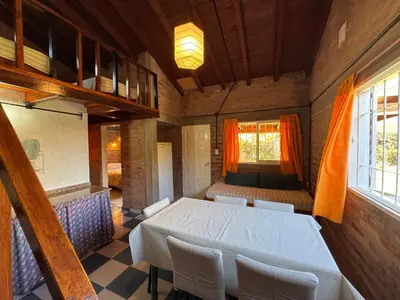 a room with a white table and chairs and a window at Casa Terra in Mina Clavero