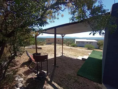 a barbecue under a pavilion in a yard at Cabaña La Abuela Chicha - Tanti in Tanti