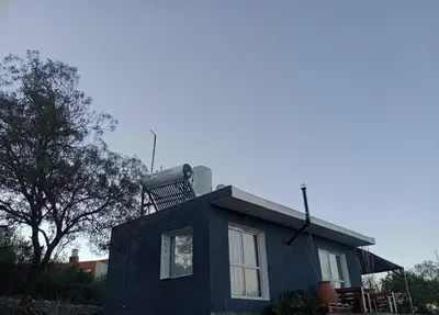 a small blue house with a rooftop at Cabaña La Abuela Chicha - Tanti in Tanti