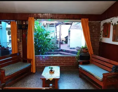 a living room with two benches and a window at Independencia in Santa Rosa de Calamuchita