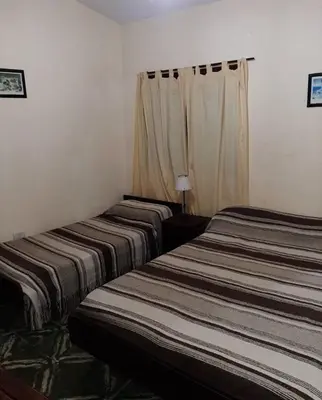 two beds sitting next to each other in a room at Independencia in Santa Rosa de Calamuchita