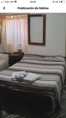 a bedroom with a bed with two towels on it at Independencia in Santa Rosa de Calamuchita