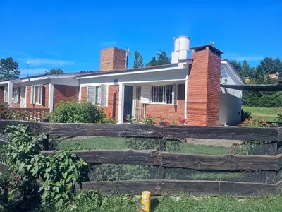 a house with a fence in front of it at Cabañas Kay Pacha in San Antonio de Arredondo