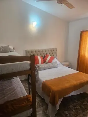 a bedroom with two bunk beds and a ceiling at Cabañas Kay Pacha in San Antonio de Arredondo