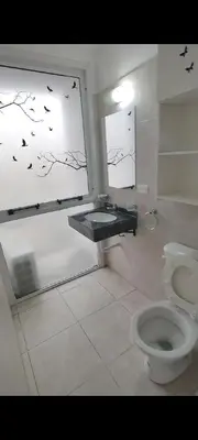 a bathroom with a toilet and a window with birds on it at Departamento in Cordoba