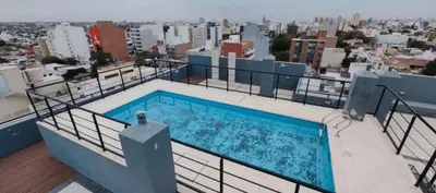 a swimming pool on the roof of a building at Departamento in Cordoba