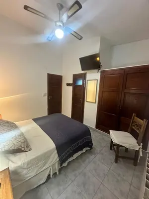 a bedroom with a bed and a ceiling fan at Hotel Tanti Spa & Resort in Tanti