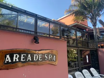 a sign on the side of a building with chairs at Hotel Tanti Spa & Resort in Tanti