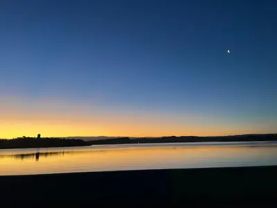 a sunset over a body of water with the sky at Departamentos La Morita in Embalse