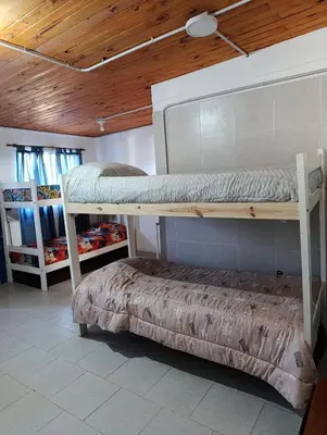a room with two bunk beds and a bench at Rio Segundo Colo 5 in Río Segundo