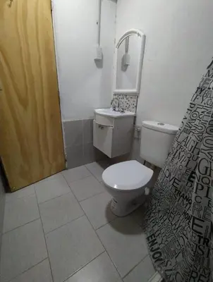 a small bathroom with a toilet and a shower at Rio Segundo Colo 5 in Río Segundo