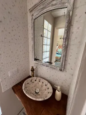 a bathroom with a sink and a mirror at LA VALENTINA casa de campo in Villa Cura Brochero