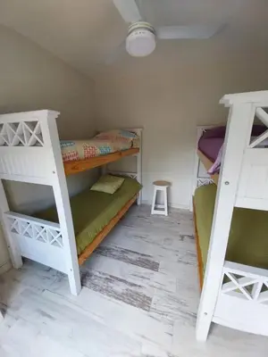a room with two bunk beds and a table at LA VALENTINA casa de campo in Villa Cura Brochero