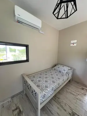a bedroom with a bed and a window at LA VALENTINA casa de campo in Villa Cura Brochero