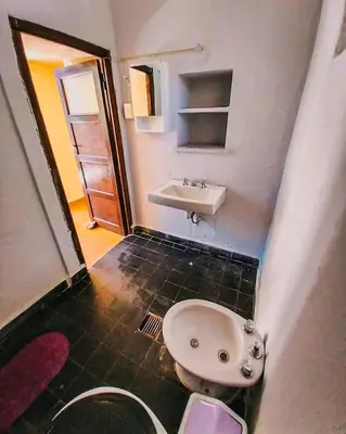 a bathroom with a sink and a toilet at Hostel La Resolana in Villa Alpina