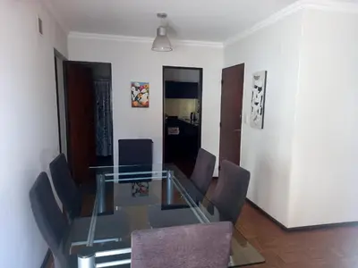 a glass table and chairs in a room at Balcon2k in Cordoba