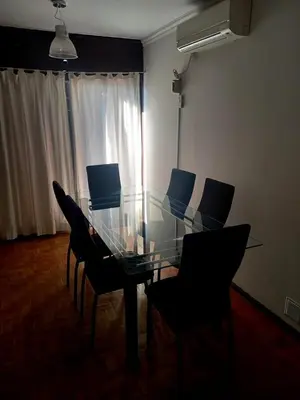a dining room with a glass table and chairs at Balcon2k in Cordoba