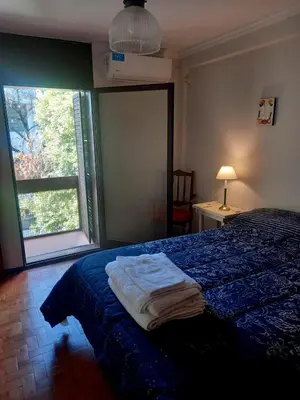 a bedroom with a bed and a large window at Balcon2k in Cordoba