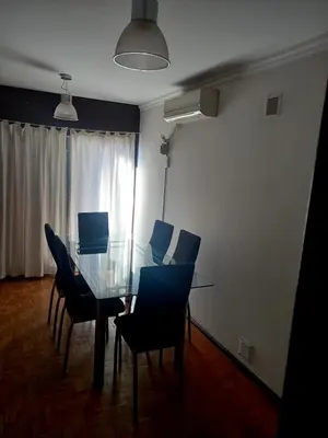 a dining room with a glass table and chairs at Balcon2k in Cordoba