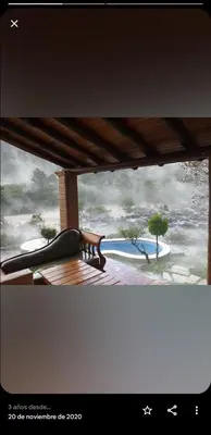 a bench on a porch with a view of a pool at Lagriega in Cuesta Blanca