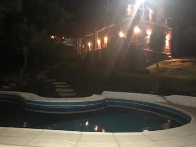 a house at night with a pool in the yard at Lagriega in Cuesta Blanca
