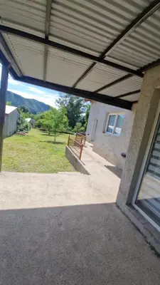 a view from the inside of a house with a bench at 