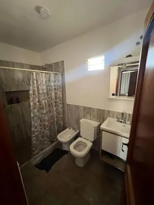 a bathroom with a toilet and a shower and a sink at 