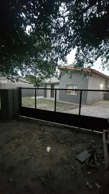 a fence in front of a house with a building at 